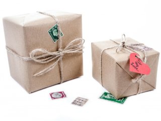 two packages wrapped in brown paper with twine ribbons